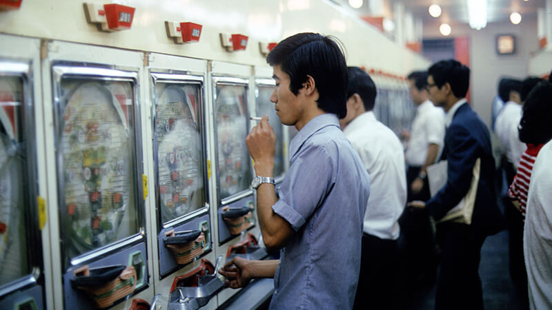 Min Jin Lee Pachinko essay: man smoking in a Pachinko parlour in Japan