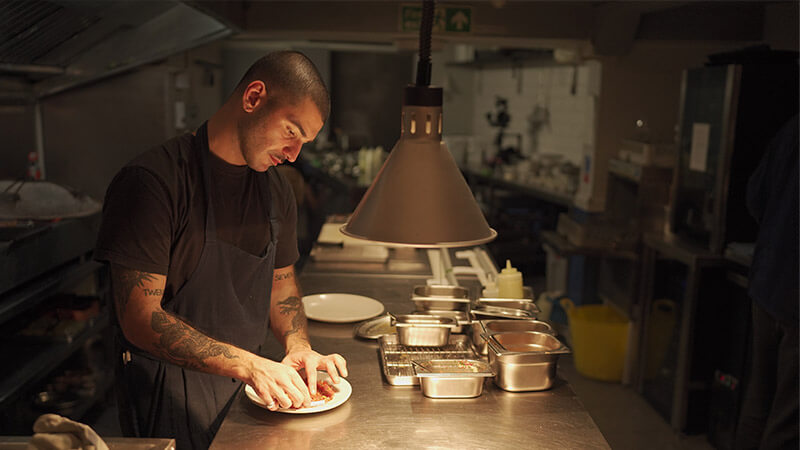 Chef Sertac Dirik preparing a dish at modern Turkish restaurant Mangal II, London