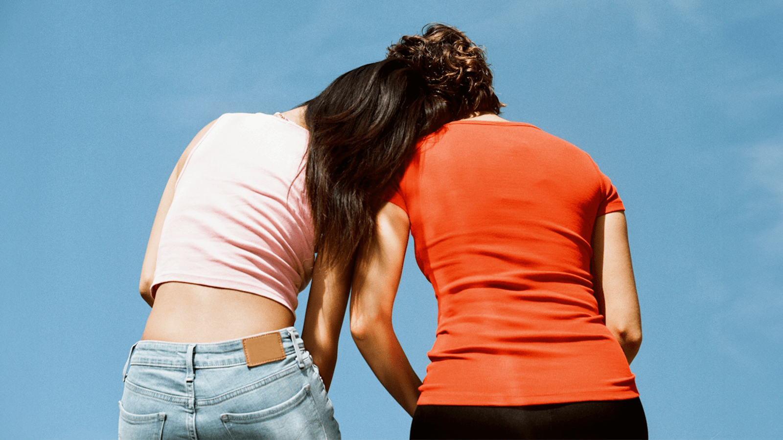 Two friends sitting together looking at the sky