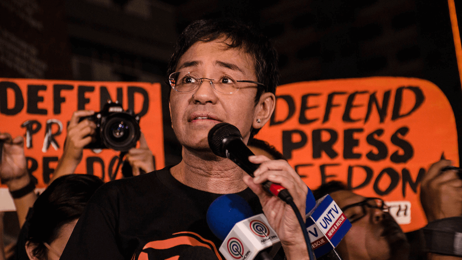 Activist Maria Ressa speaking at a protest